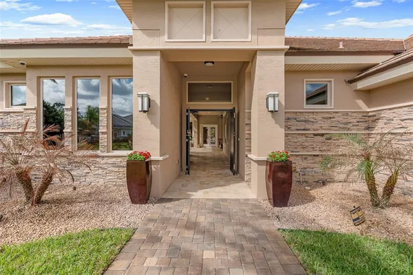 a kitchen with stainless steel appliances kitchen island granite countertop a refrigerator and cabinets