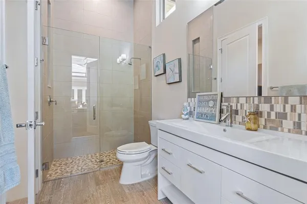 an aerial view of residential houses with outdoor space and street view