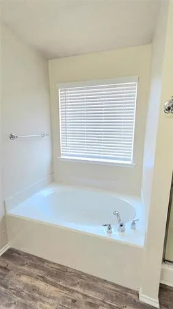 a room with a sink and wooden floor