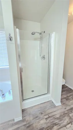 a bathroom with a double vanity sink a mirror and a bathtub