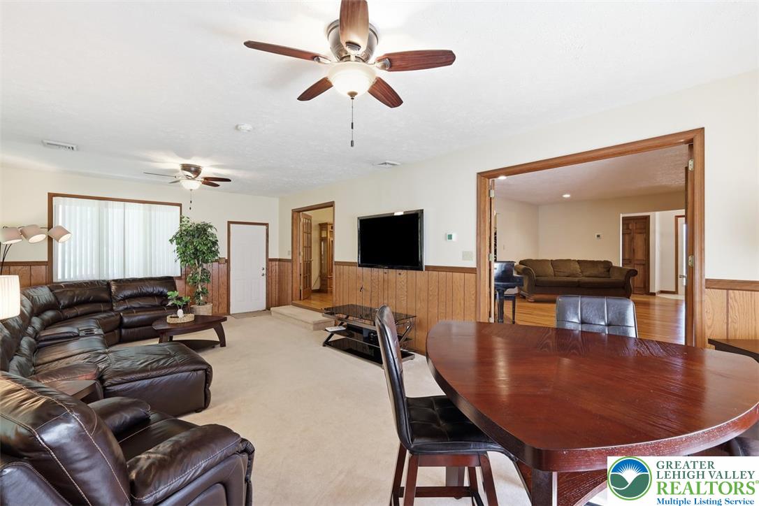 123 Meadow Road Blakeslee, PA 18610 - Photo 12 of 53 Warm wood wainscoting and cozy carpeting ground this welcoming open concept living space.