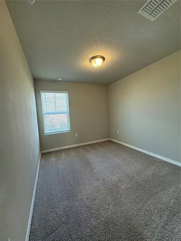 an empty room with a empty space and windows