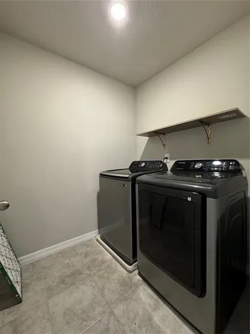 a utility room with washer and dryer