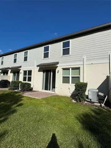 a view of a house with a yard and sitting area