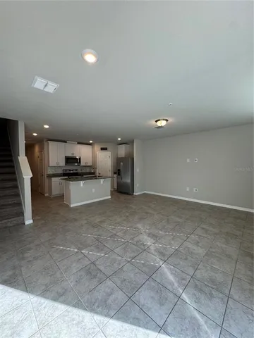 a view of a room with a kitchen