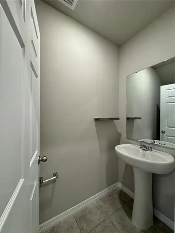 a bathroom with a sink mirror and toilet