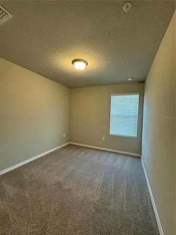 an empty room with a empty space and windows