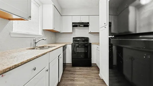 a kitchen with a sink stove and refrigerator