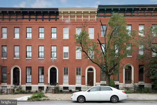 a front view of a building with parking space