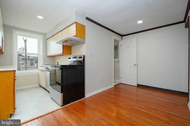 a kitchen with a sink and a stove top oven