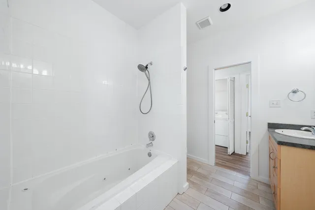 a bathroom with a bathtub and a shower