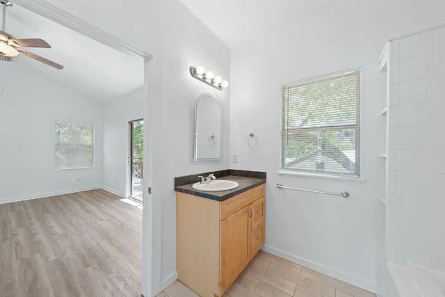 a kitchen with granite countertop a stove and a wooden floors