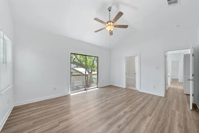 wooden floor in an empty room with a window