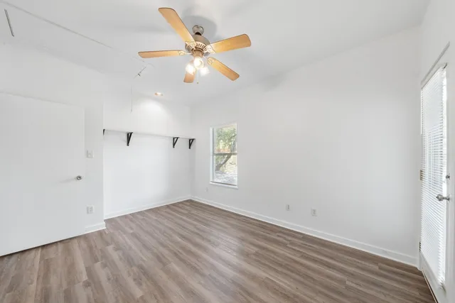 wooden floor in an empty room with a window