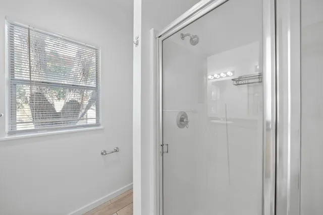 a bathroom with a glass shower door