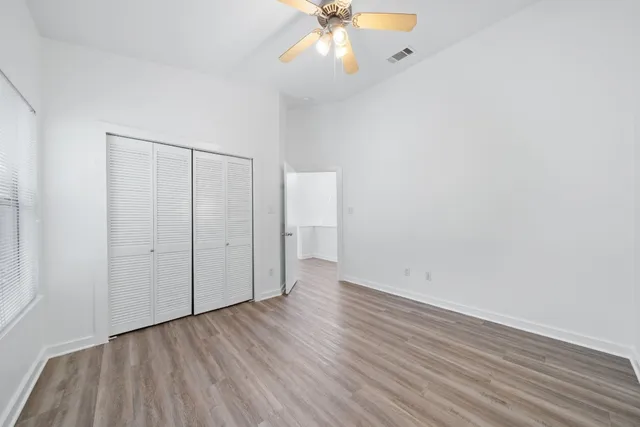 a view of an empty room with wooden floor