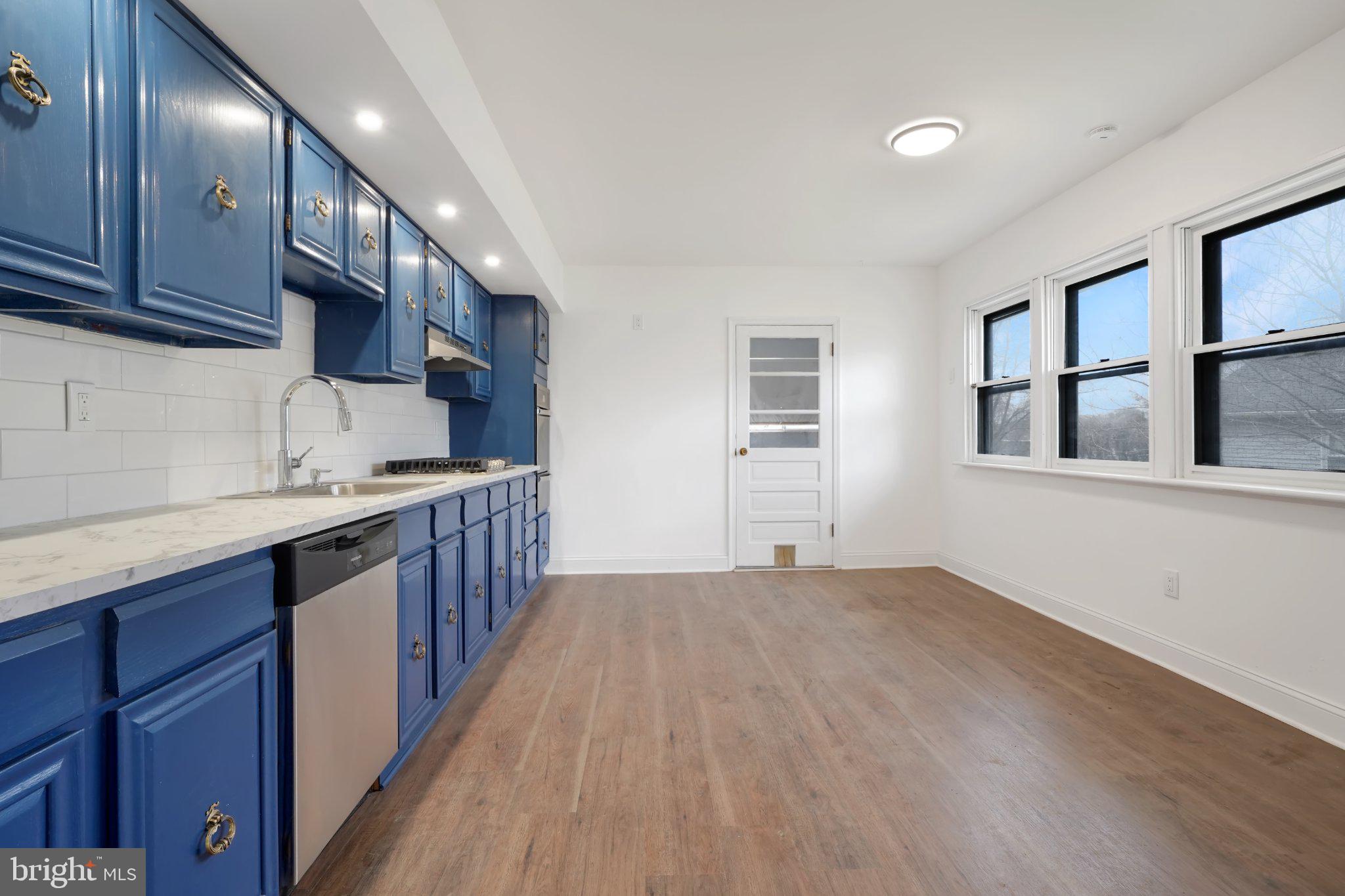 1718 Kohl Street Philadelphia, PA 19115 - Photo 11 of 34 Bright kitchen with bold blue cabinetry.