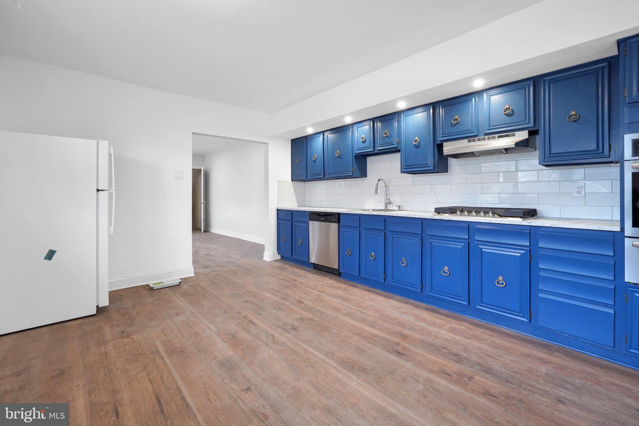 1718 Kohl Street Philadelphia, PA 19115 - Photo 13 of 34 Vibrant blue kitchen with modern flair.