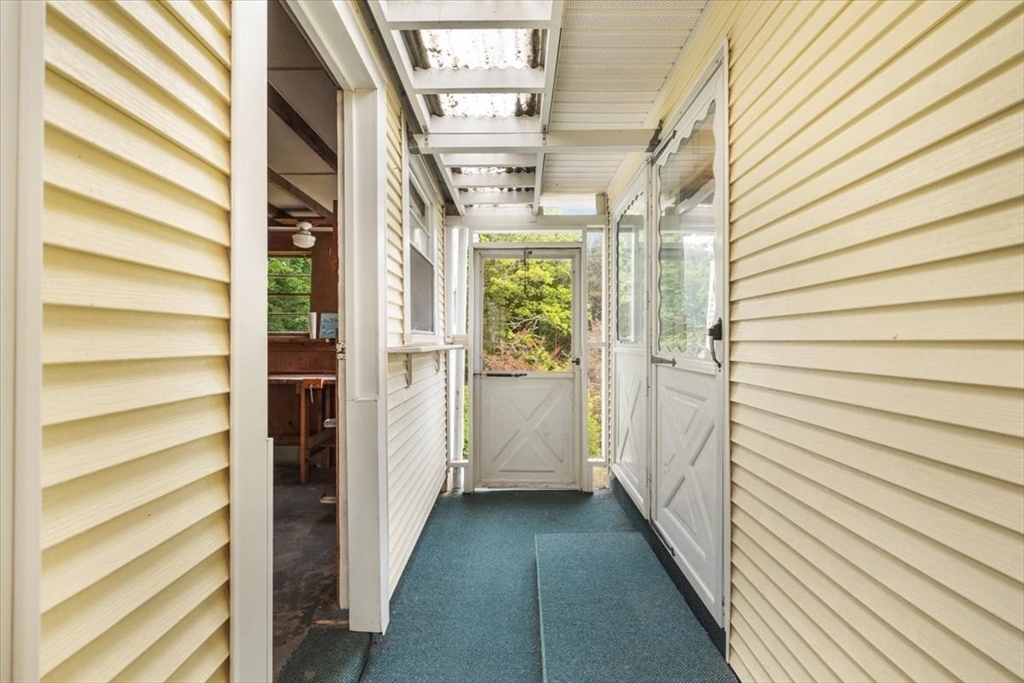 48 Canal View Road Bourne, MA 02532 - Photo 8 of 35 a view of a balcony with wooden floor and door