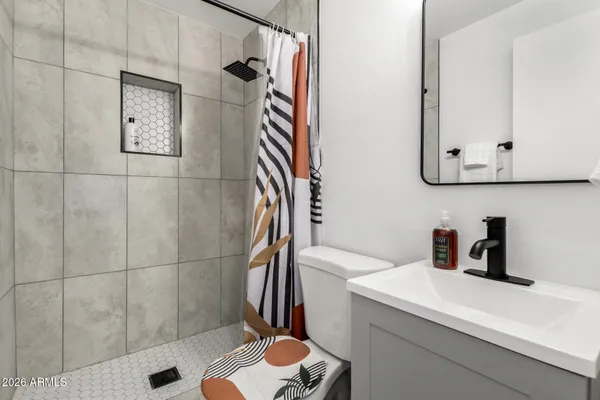 a bathroom with a sink toilet and shower