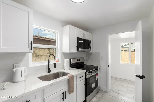 a kitchen with a sink stove and microwave