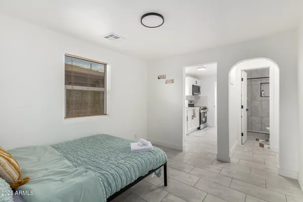 a bedroom with a bed and a chandelier