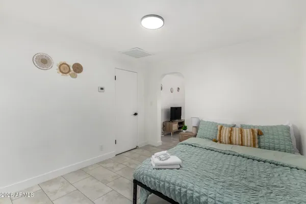 a bedroom with a bed and a table in it