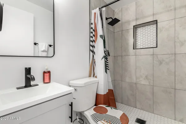 a bathroom with a sink toilet and shower