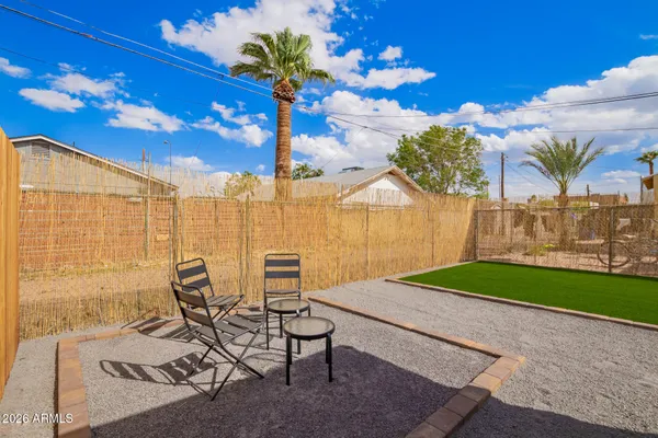 a view of a patio with table and chairs and potted plants