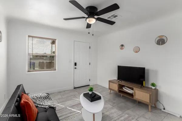 a living room with furniture and a flat screen tv