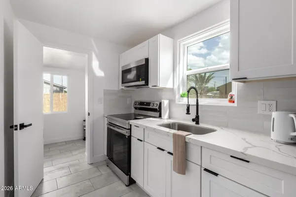 a kitchen with a sink stove and microwave