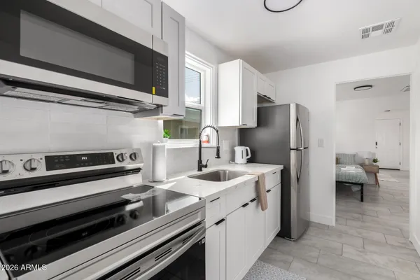 a kitchen with a refrigerator stove and sink