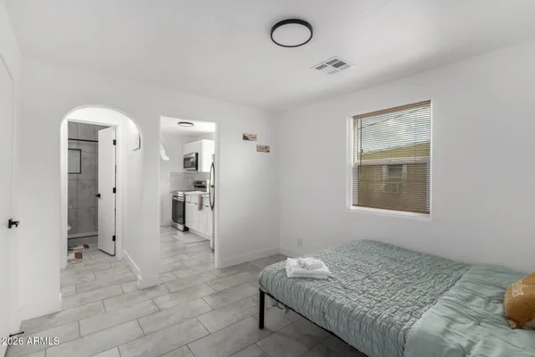a living room with a bed furniture and a window