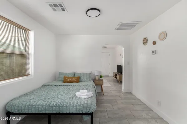 a bedroom with a bed and window