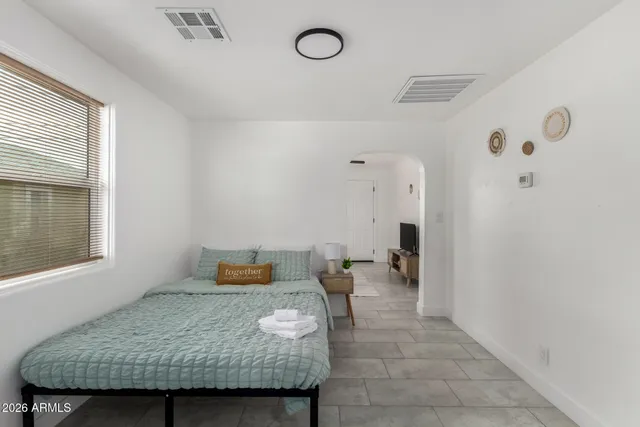 a bedroom with a bed and window