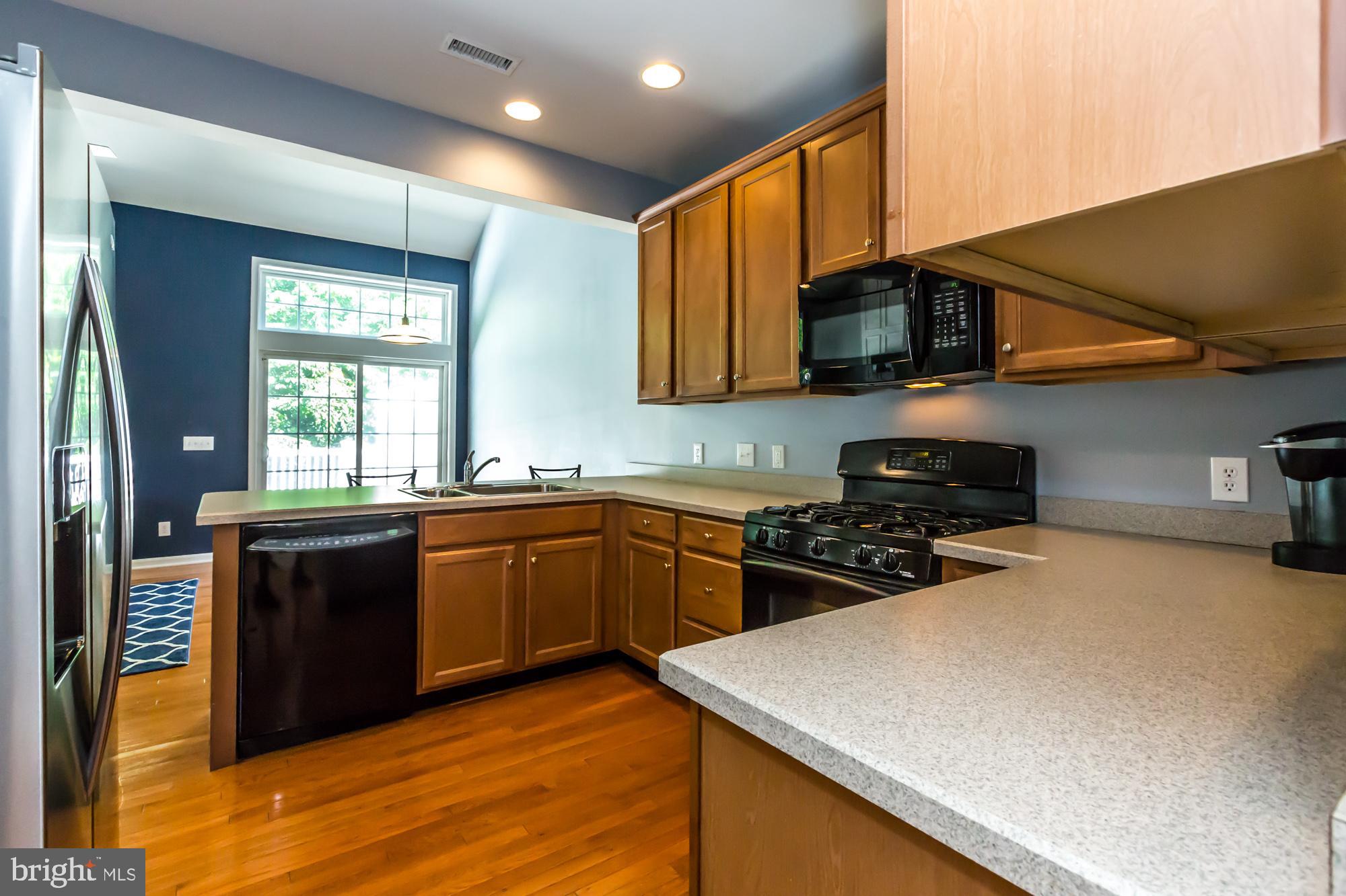 684 Churchill Road Chester Springs, PA 19425 - Photo 14 of 54 a kitchen with stainless steel appliances granite countertop a stove a sink and a microwave