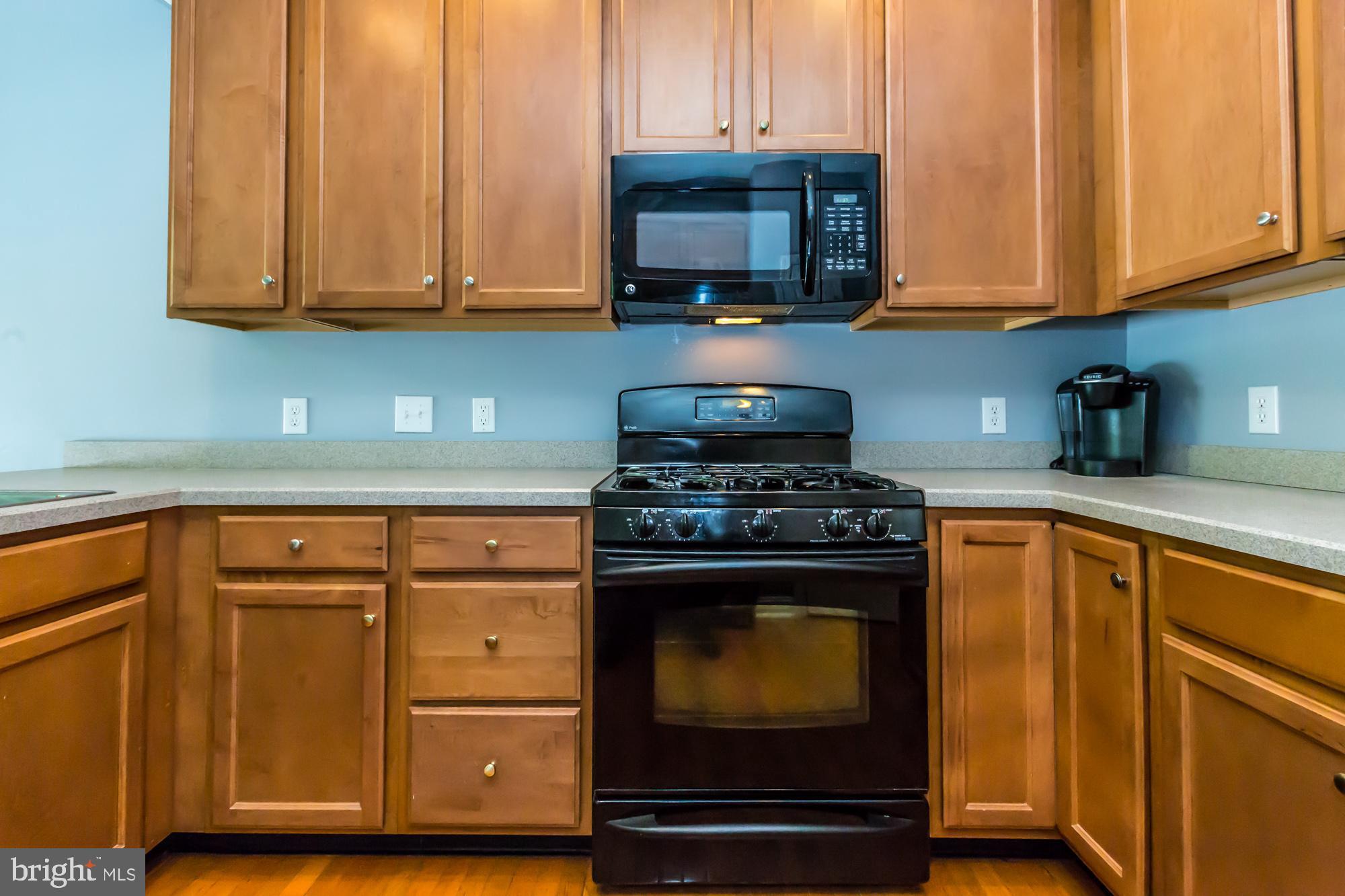 684 Churchill Road Chester Springs, PA 19425 - Photo 15 of 54 a kitchen with wooden cabinets and a stove top oven