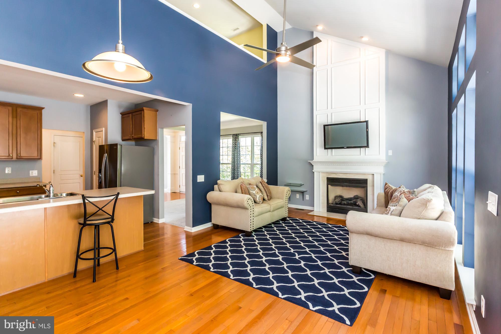 684 Churchill Road Chester Springs, PA 19425 - Photo 21 of 54 a living room with furniture a fireplace and a flat screen tv