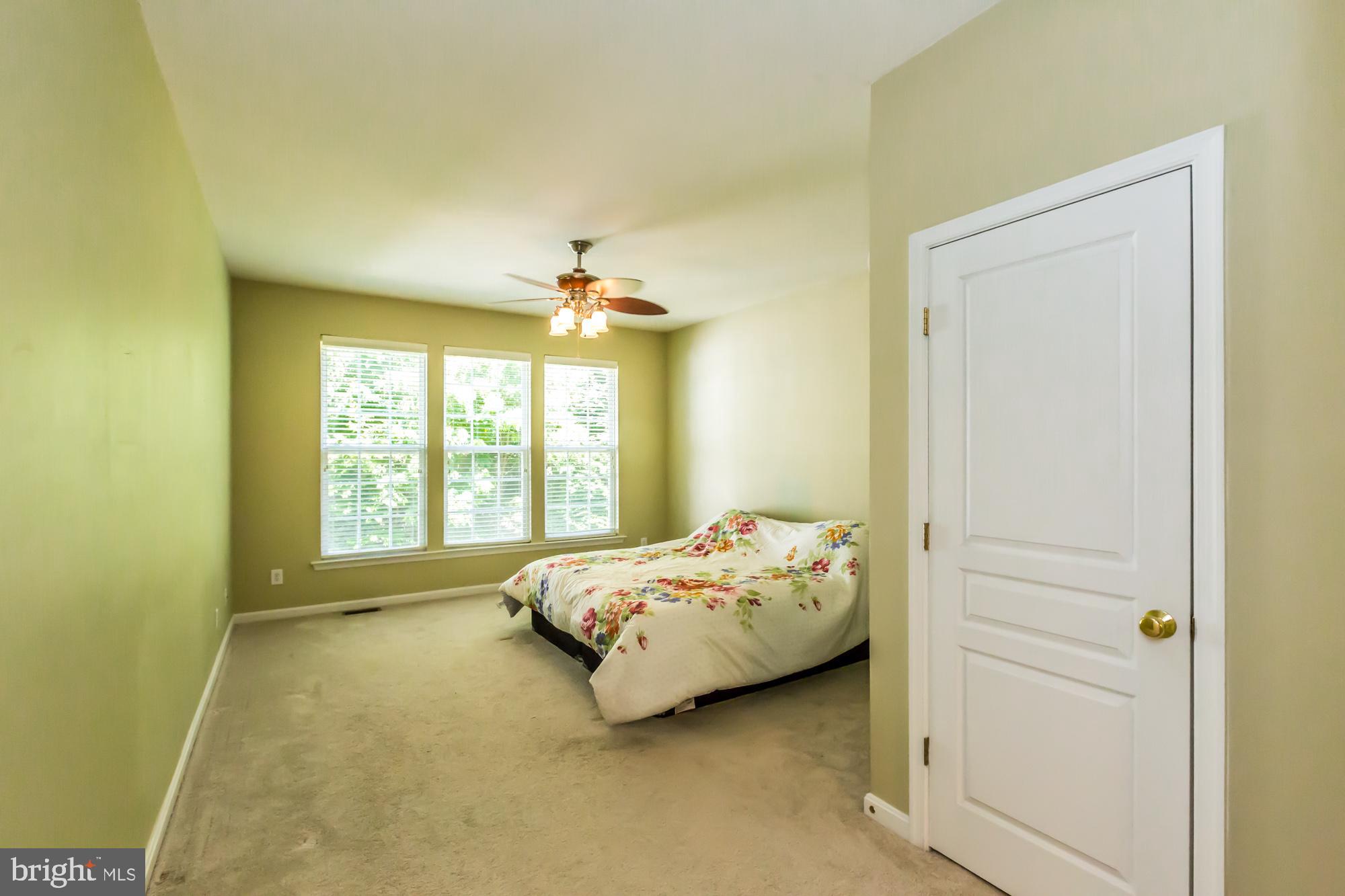 684 Churchill Road Chester Springs, PA 19425 - Photo 24 of 54 a bed sitting in a bedroom next to a window