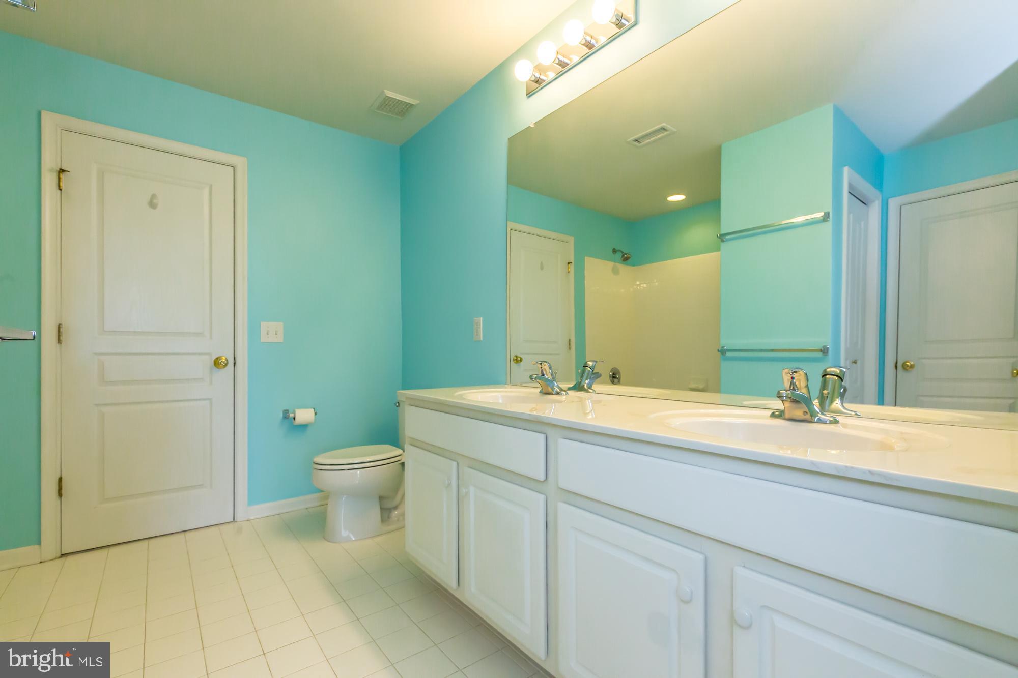 684 Churchill Road Chester Springs, PA 19425 - Photo 36 of 54 a spacious bathroom with a granite countertop sink mirror and a toilet