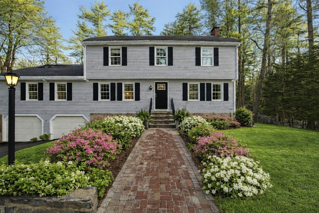 a front view of a house with garden