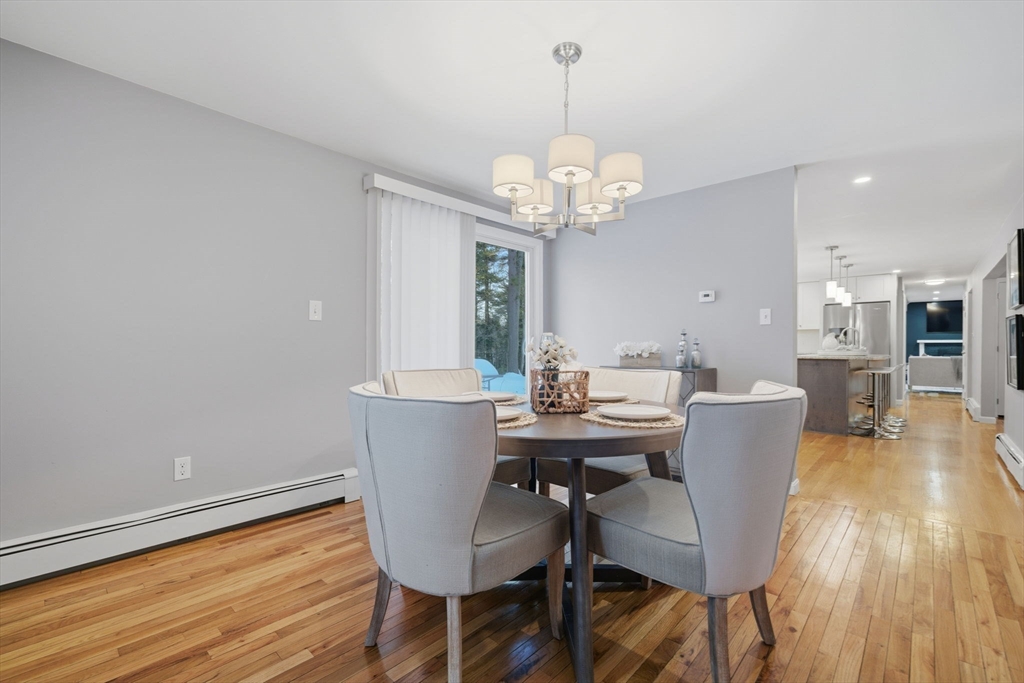 40 Curtis Road Boxford, MA 01921 - Photo 11 of 34 a view of a dining room with furniture wooden floor and chandelier