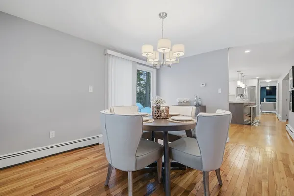 a view of a dining room with furniture wooden floor and chandelier