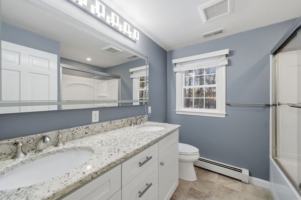 40 Curtis Road Boxford, MA 01921 - Photo 16 of 34 a bathroom with a granite countertop sink a toilet and a window