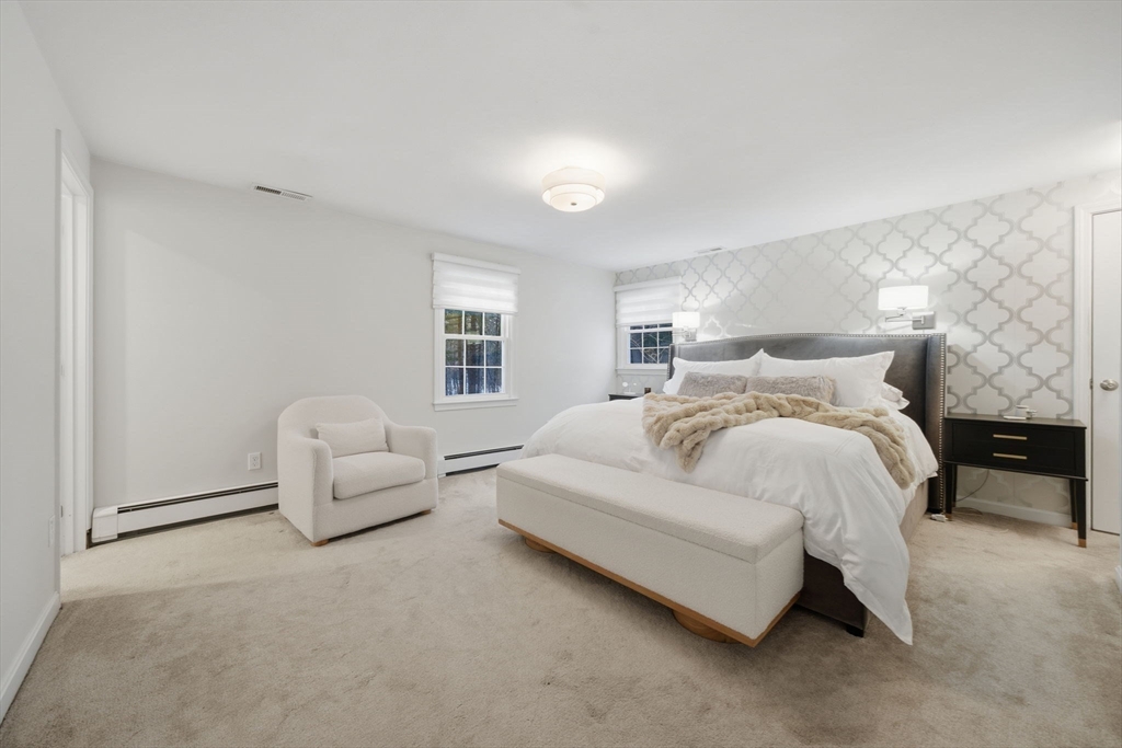 40 Curtis Road Boxford, MA 01921 - Photo 17 of 34 a spacious bedroom with a bed and a couch