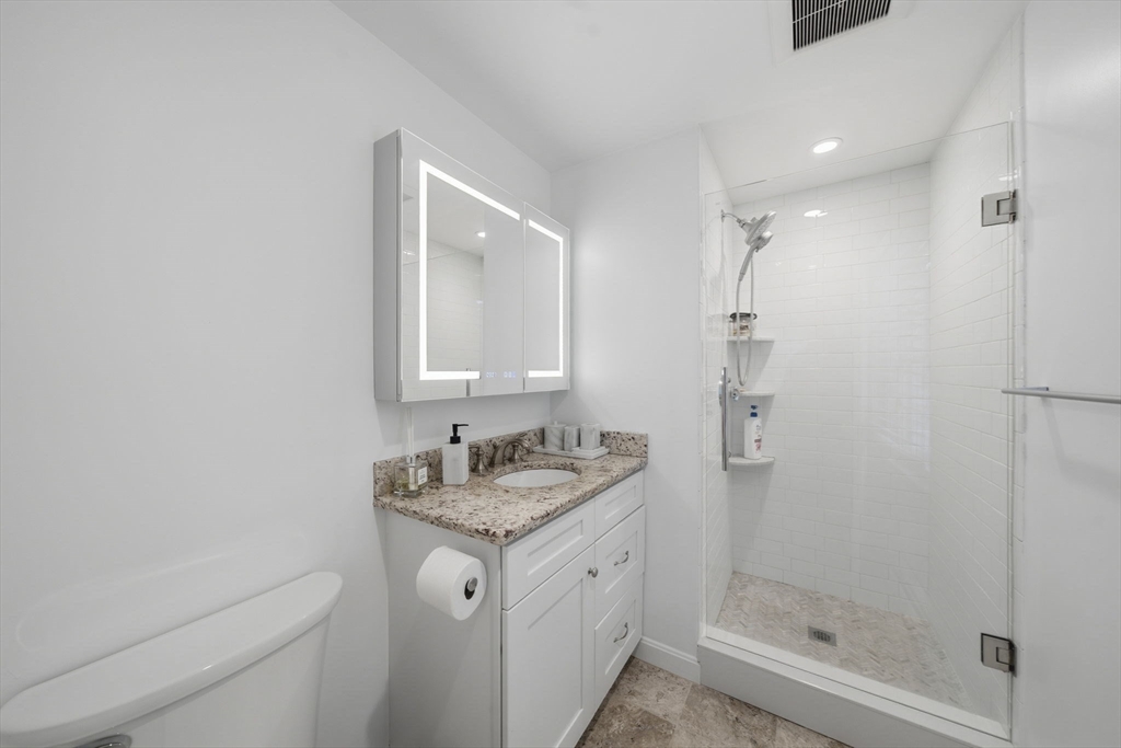 40 Curtis Road Boxford, MA 01921 - Photo 19 of 34 a bathroom with a granite countertop sink a mirror and shower