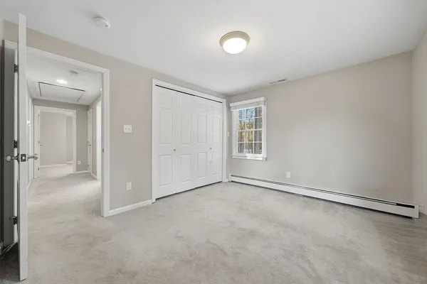 an empty room with windows and closet
