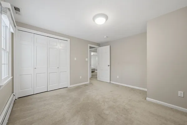 a view of an empty room and closet area
