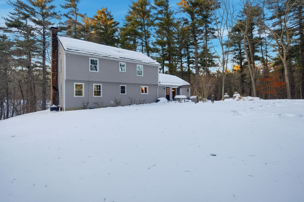 40 Curtis Road Boxford, MA 01921 - Photo 31 of 40 a front view of a house with a yard covered in snow