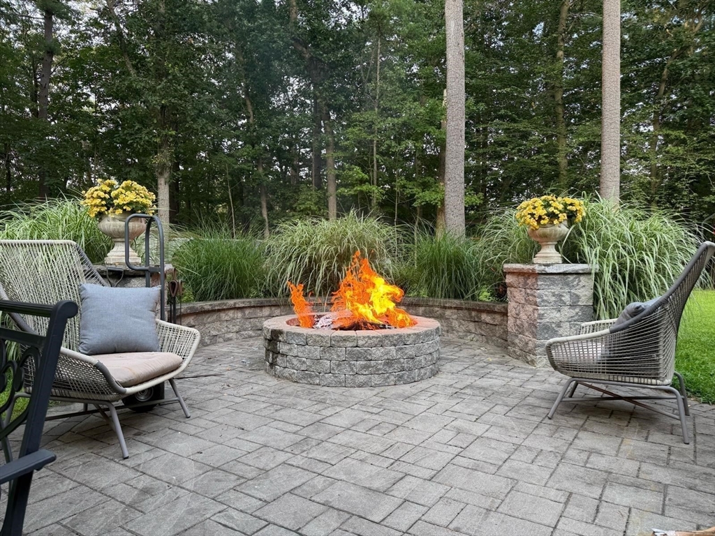 40 Curtis Road Boxford, MA 01921 - Photo 32 of 34 a backyard of a house with fountain table and chairs